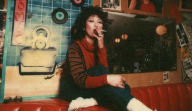 movie still from Atomic Cafe Nancy sitting on red booth